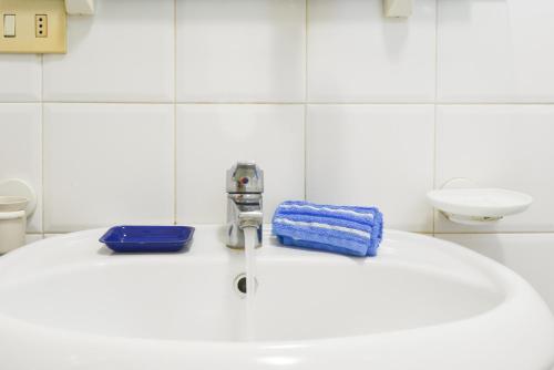a bathroom with a sink and a faucet at Appartamento Golfo di Campo in Campo nell'Elba