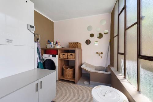 a bathroom with a toilet and a washing machine at Casa Teresa Suite in Como in Como