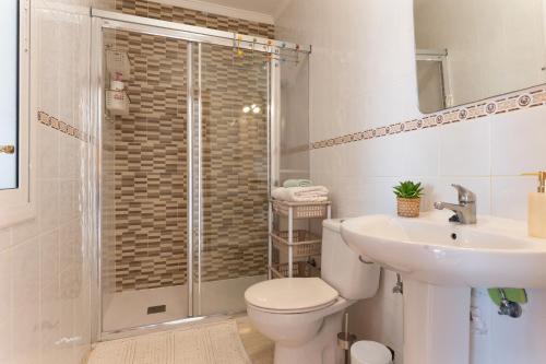 a bathroom with a shower and a toilet and a sink at La Orilla in Costa Calma