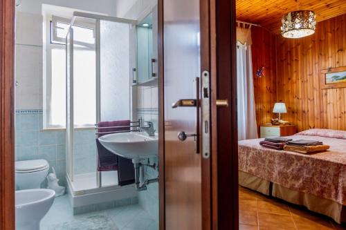 a bathroom with a sink and a bed at Principina tra mare e natura in Principina Terra