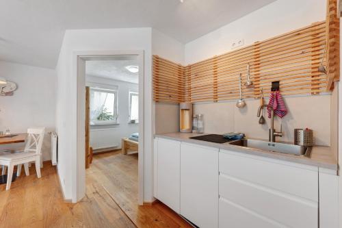 a kitchen with white cabinets and a sink at Ruhbauernhof in Kirchzarten