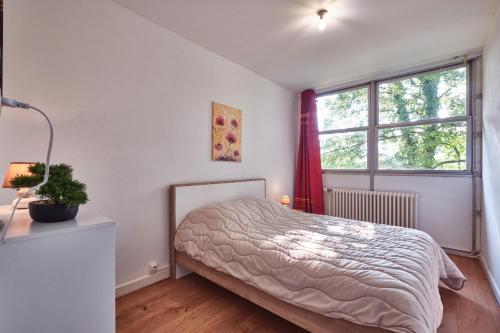 a bedroom with a bed and a window at Gîte du Château St Geoire Véronique in Saint-Geoire-en-Valdaine