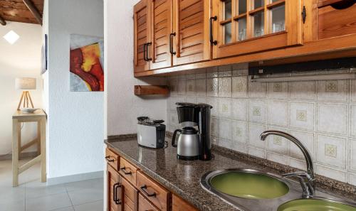 a kitchen with a sink and a coffee maker at Villetta Quattro in Costa Rei
