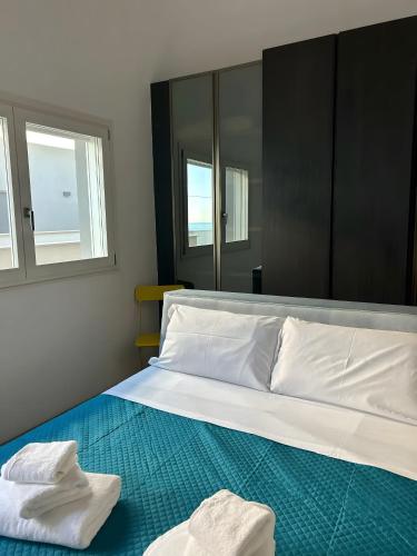 a bedroom with a bed with two towels on it at Luxury Room in Bari