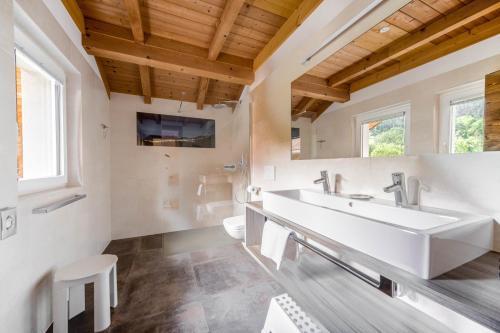 a bathroom with a white sink and a tv at Sonnleiten Sterngucker 7 in Collepietra