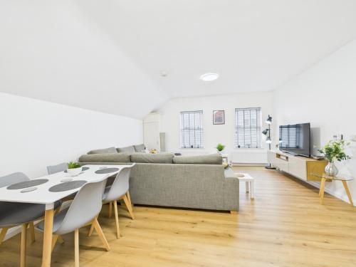a living room with a couch and a table and chairs at Kings Corner in Warrenpoint