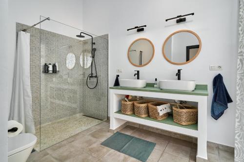 a bathroom with two sinks and a shower at El Cine in Canillas de Albaida