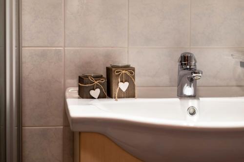 a bathroom with a sink with two candles on it at Apartment Linde- Fiechterhof in Sarntal