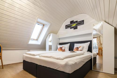 a bedroom with a large bed in a attic at Landpension Am Sommerhang in Bad Rippoldsau