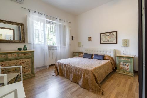 a bedroom with a bed and a mirror on the wall at Villa Massa in Polignano a Mare