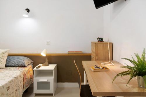 ein Schlafzimmer mit einem Bett und einem Tisch mit einer Lampe in der Unterkunft Estudio Massimo 7d in Las Palmas de Gran Canaria