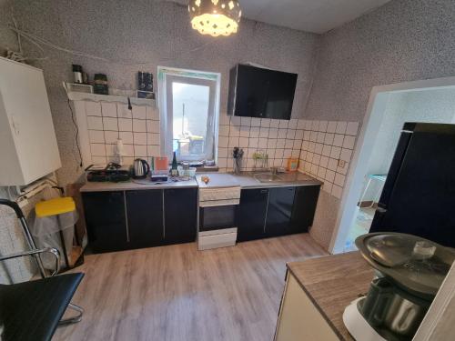 a large kitchen with a sink and a window at Ferienwohnung Plötzky in Plötzky