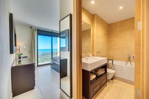 a bathroom with a sink and a tub and a toilet at Marbella Luxury Penthouse in Marbella