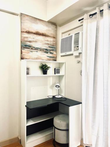 a desk in a small room with a window at Camella Northpoint Spacious 3rd Floor Unit in Davao City