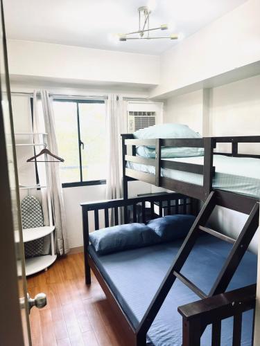 a room with two bunk beds and a window at Camella Northpoint Spacious 3rd Floor Unit in Davao City