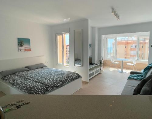 a bedroom with a bed and a table and chairs at Studio Carabela in Torrox