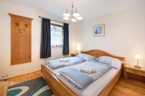 a bedroom with a bed with two pillows on it at Haus Lowe Apartment Erdgeschoss 1 in Filzmoos
