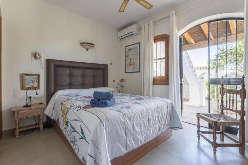 a bedroom with a bed with a blue camera on it at Casa de Junemor in Nerja