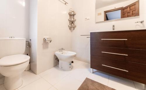 a bathroom with a toilet and a sink at Vista Hermosa in Moraira
