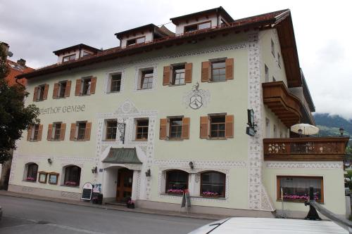 a large white building on the side of a street at Gasthof Gemse in Prutz