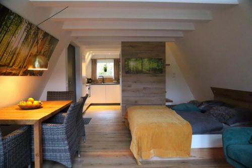 a bedroom with a bed and a table in a room at Ferienhaus Adlerhorst in Billerbeck
