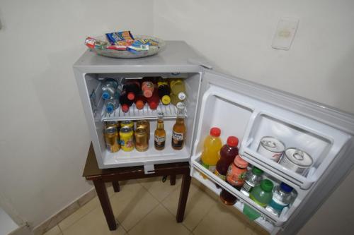 a small refrigerator filled with lots of drinks at Hotel Nuevo Tio in Valledupar