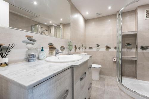 a bathroom with a sink and a shower at Pyr studio apartment in Fuengirola