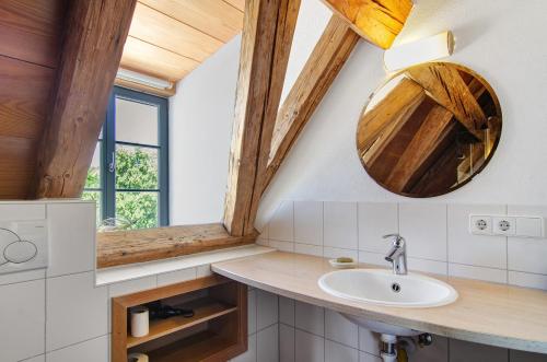 a bathroom with a sink and a mirror at Escasa Ferienwohnungen in Heiligenberg