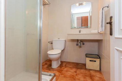 a bathroom with a toilet and a sink and a shower at Apartamento Bon Repos A7 in Cala'n Bosch