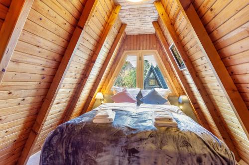 a bed in a tree house with a window at Villa Natura in Meschede