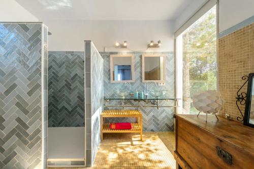 a bathroom with a shower and a wooden dresser at Cala Salada Sunset View in San Antonio
