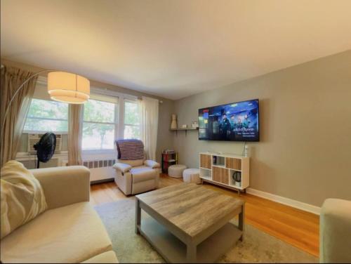 a living room with a couch and a tv on the wall at Apartment Home close to NWU & Hospitals in Evanston