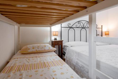 a bedroom with two beds and a wooden ceiling at Agriturismo Col Moschin in Grosseto
