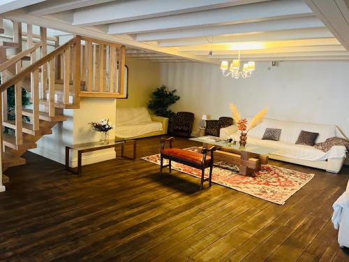 a living room with a couch and a table at Maison bonheur -Parking- piscine -espace de jeux- avec 6 suites avec SDB in Bourg-en-Bresse