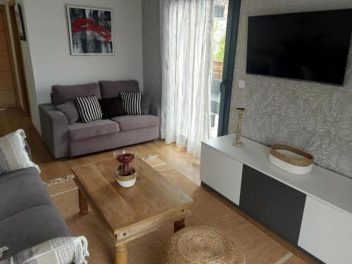 a living room with a couch and a table at Apto playa Alojamientos Marte in Suances