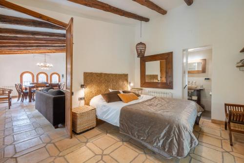 a bedroom with a bed and a dining room at Casa Argentera Full House in Argentera