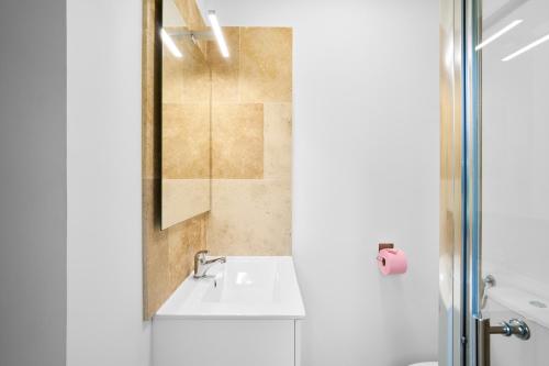 a white bathroom with a sink and a shower at Maison La Plaine, En Périgord in Saint-Laurent-la-Vallée
