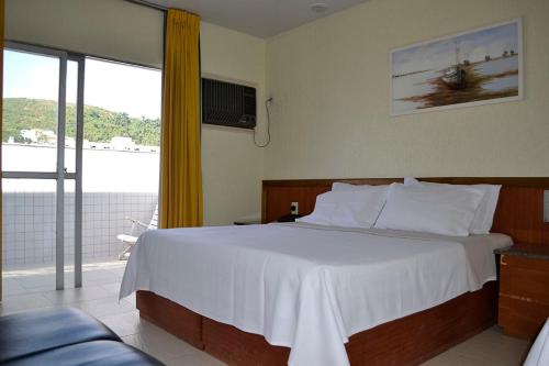 Postel nebo postele na pokoji v ubytování Hotel Barao Da Taquara