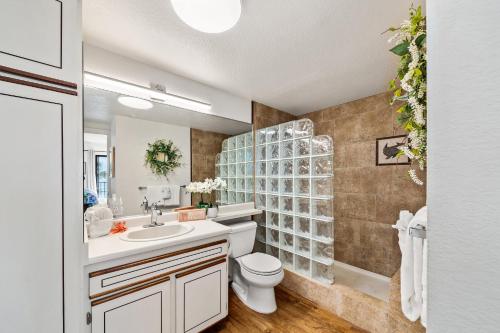 a bathroom with a sink and a toilet and a shower at Lauloa 303 in Maalaea