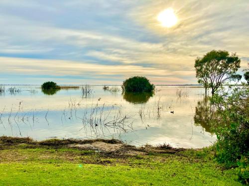 a large body of water with trees in it at Lake Colac Holiday Park in Colac
