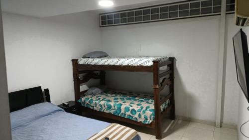 a room with two bunk beds and a bed at 03 Aires Acondicionados in Cúcuta