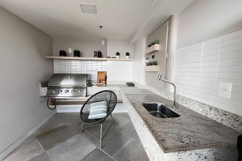 a kitchen with a sink and a stove at Moderno com piscina e perto da praia in Rio de Janeiro