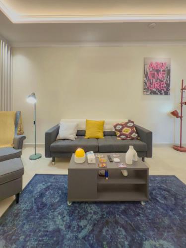 a living room with a couch and a coffee table at Spacious apartment next to the financial towers B10 in Quai