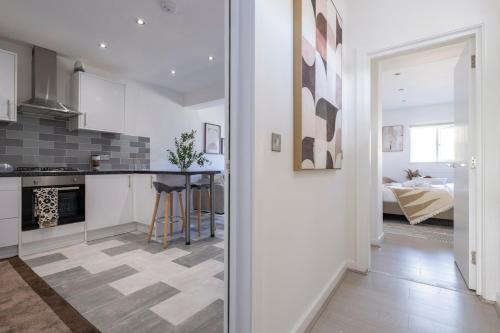 a kitchen and living room with a table in it at Designer 1BR I Work-From-Home Ready I Fast Wi-Fi in Slades Green