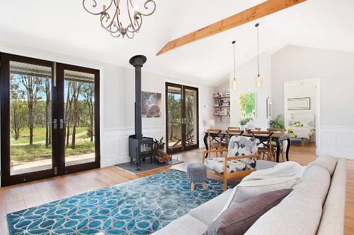 a living room with a couch and a table at Block Eight Estate Hunter Valley in Belford