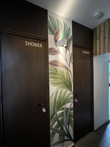 a room with two elevators with a flower mural on the wall at La Selva Hostel in Mexico City