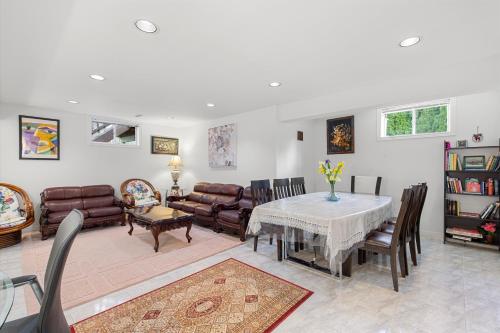 a living room with a table and leather furniture at Home Away From Home in Richmond Hill