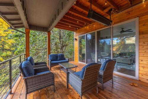 a screened in porch with chairs and a table at Evergreen Retreat AB 30 Night Minimum home in White Salmon