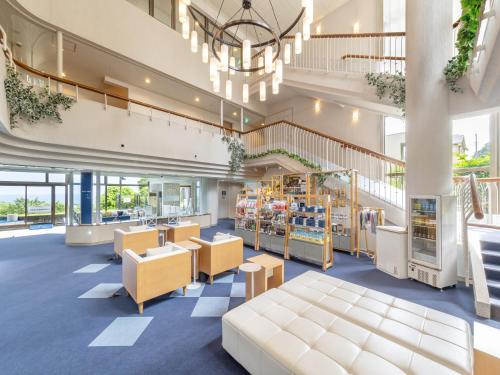 a view of the lobby of a library with tables and chairs at Wan Wan Paradise Premier Izukogen in Ito