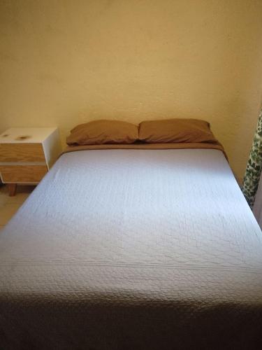 a bedroom with a bed and a nightstand next to a bed sidx sidx sidx at Departamento E-5 metro Copilco UNAM Coyoacan in Mexico City